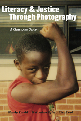 Book cover of Literacy and Justice Through Photography, showing a boy making a muscle pose with his arm.