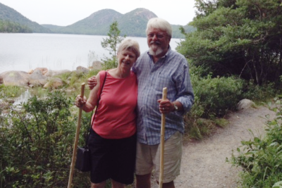 Lorna and Bill Chafe hiking by a lake.