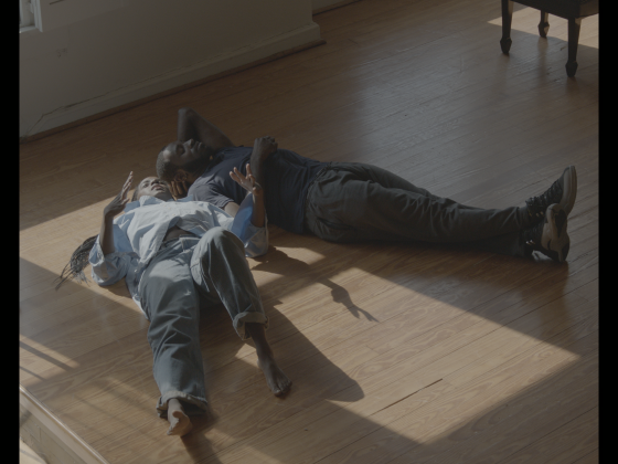 Knight and her cousin lay on a wood floor in beautiful light from a nearby window. 